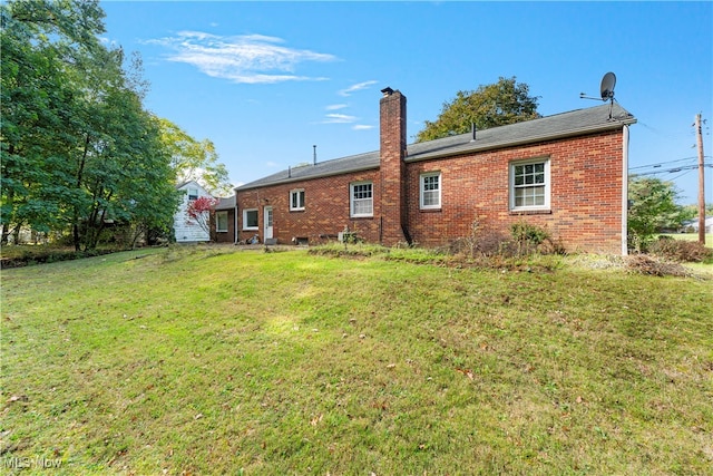 rear view of house with a yard