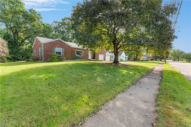 view of front of property with a front yard and a garage