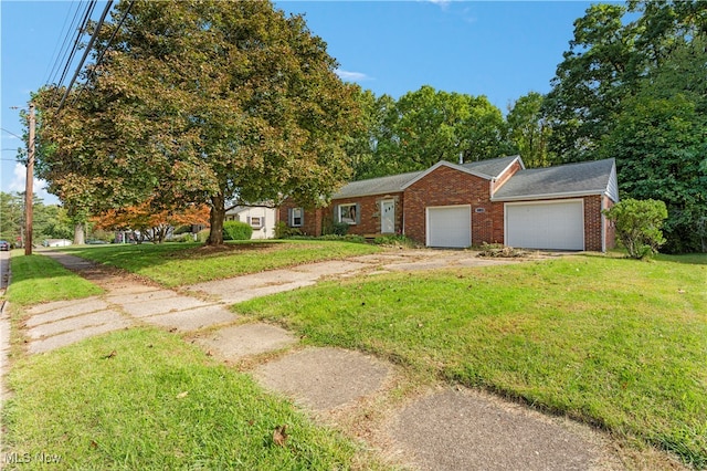 view of front of home with a front yard and a garage