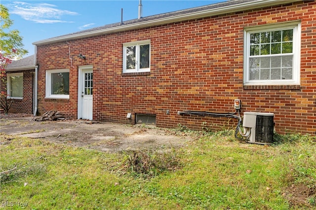 rear view of property with central AC unit