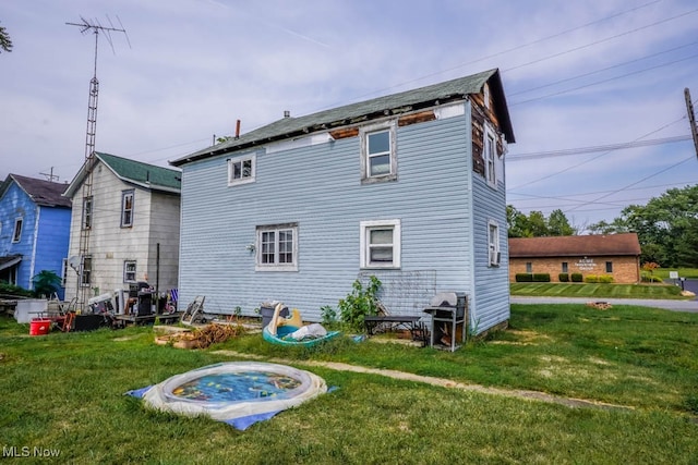 back of house with a yard