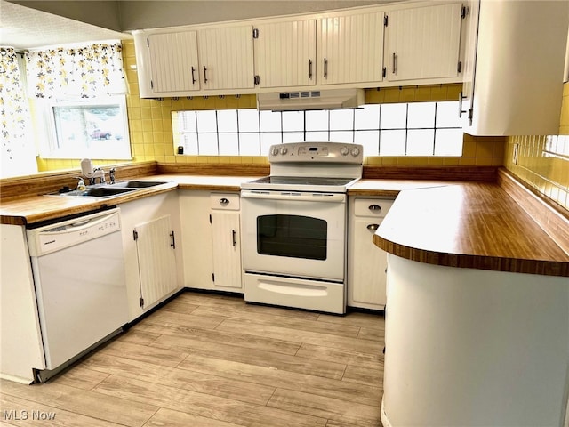 kitchen with white cabinetry, light wood-type flooring, white appliances, and range hood