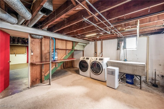 basement featuring a sink and washing machine and clothes dryer