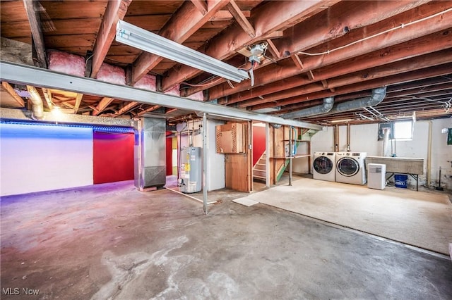 basement with heating unit, stairway, washer and clothes dryer, and gas water heater