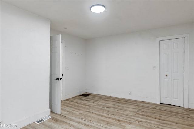 spare room featuring light wood-type flooring