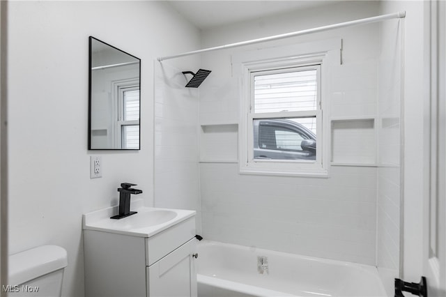 full bathroom with vanity, toilet, and tiled shower / bath