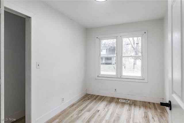 empty room with light hardwood / wood-style floors