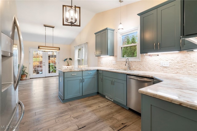 kitchen featuring appliances with stainless steel finishes, plenty of natural light, hanging light fixtures, and sink