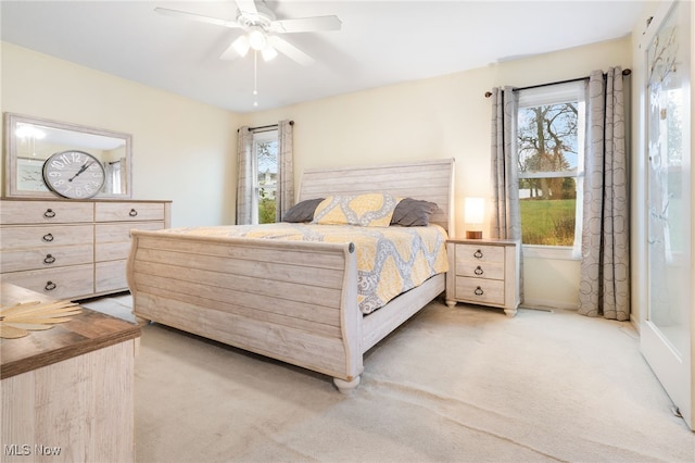 bedroom featuring ceiling fan and light colored carpet