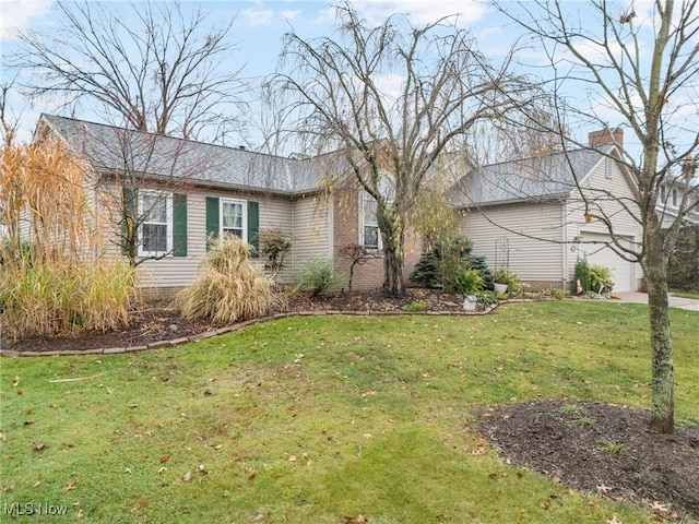 view of front of property with a garage and a front lawn