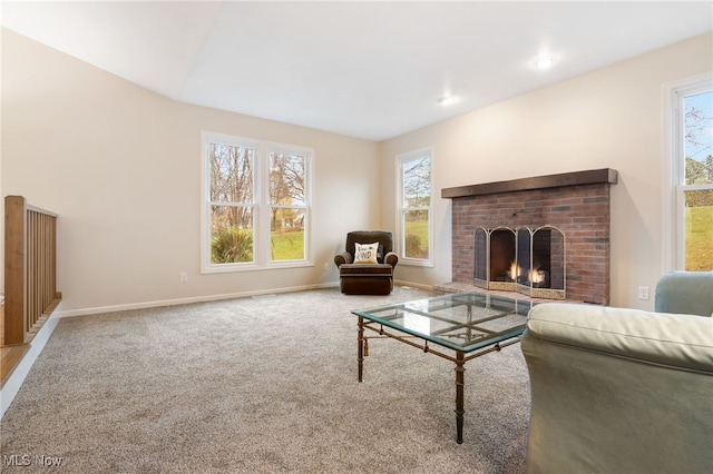 living room featuring carpet flooring, a fireplace, and a healthy amount of sunlight