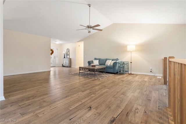 living room with ceiling fan, light hardwood / wood-style floors, and lofted ceiling