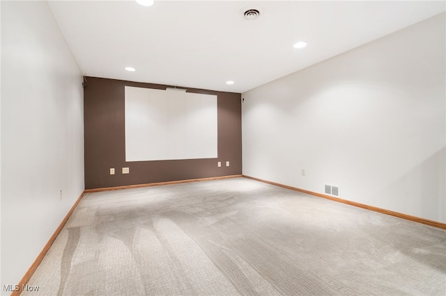 unfurnished room featuring light colored carpet