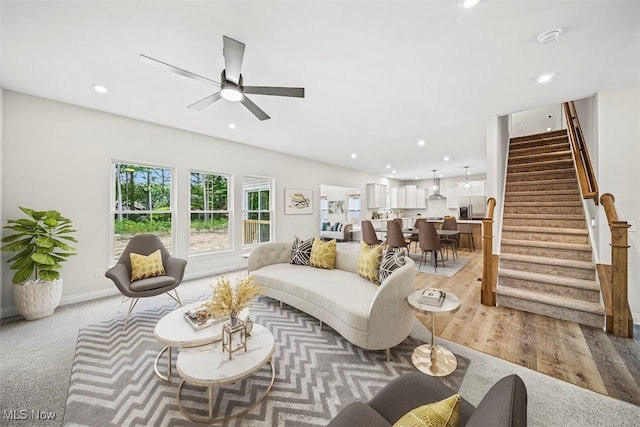 living room featuring ceiling fan and light hardwood / wood-style floors