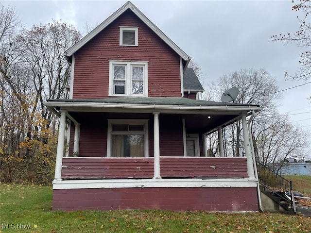 view of side of property featuring covered porch