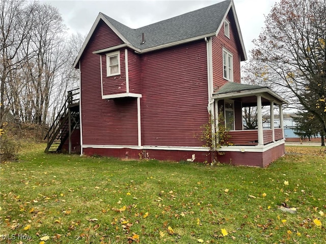 view of property exterior with covered porch and a yard