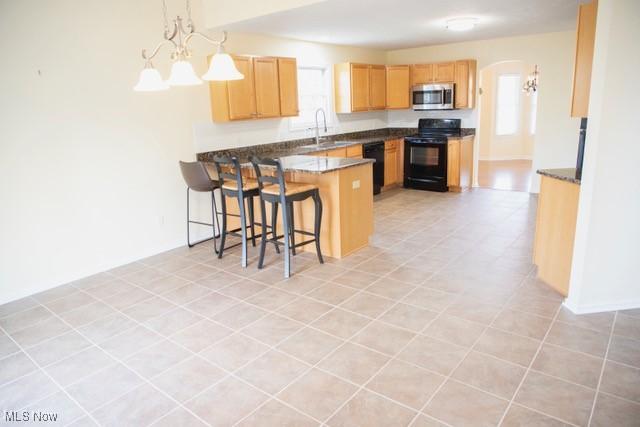 kitchen with pendant lighting, black appliances, sink, a notable chandelier, and kitchen peninsula