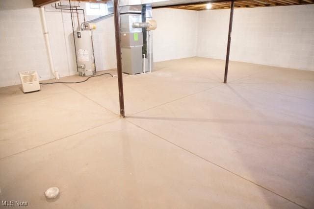 basement featuring heating unit and water heater