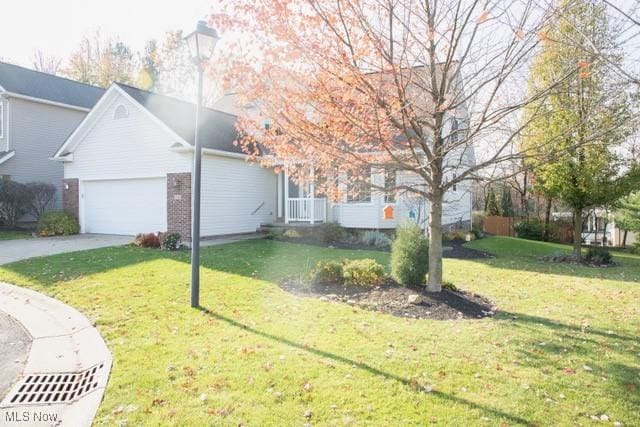 view of front facade featuring a garage and a front lawn