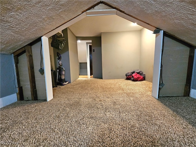 bonus room featuring carpet flooring, a textured ceiling, and vaulted ceiling