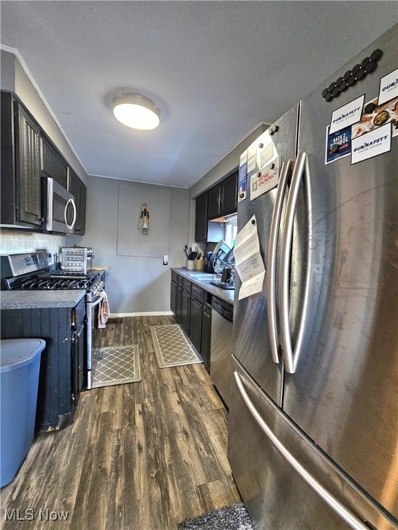 kitchen featuring dark hardwood / wood-style flooring and stainless steel appliances