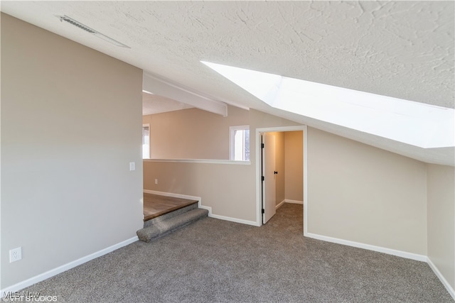 bonus room featuring carpet flooring, a textured ceiling, and lofted ceiling