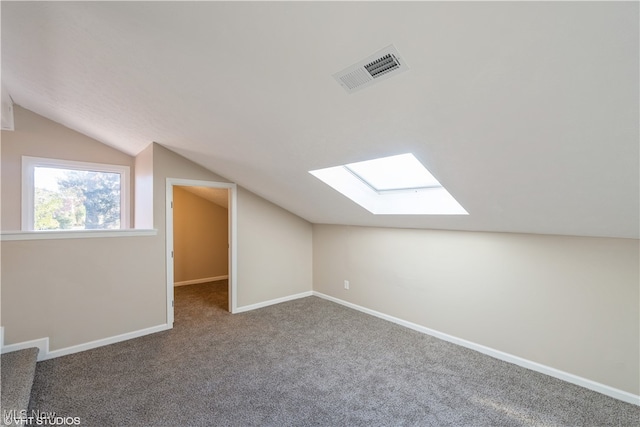 bonus room featuring carpet flooring and lofted ceiling with skylight