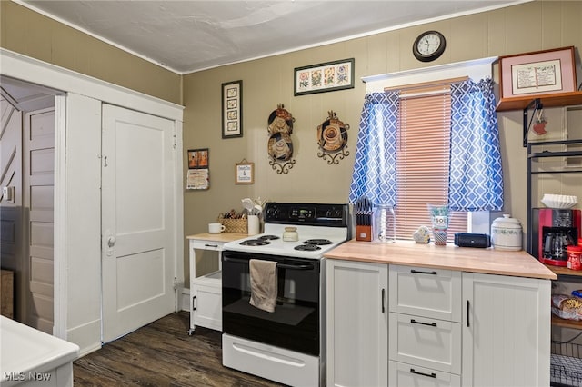 kitchen with white range with electric stovetop, dark hardwood / wood-style flooring, white cabinetry, and wooden walls