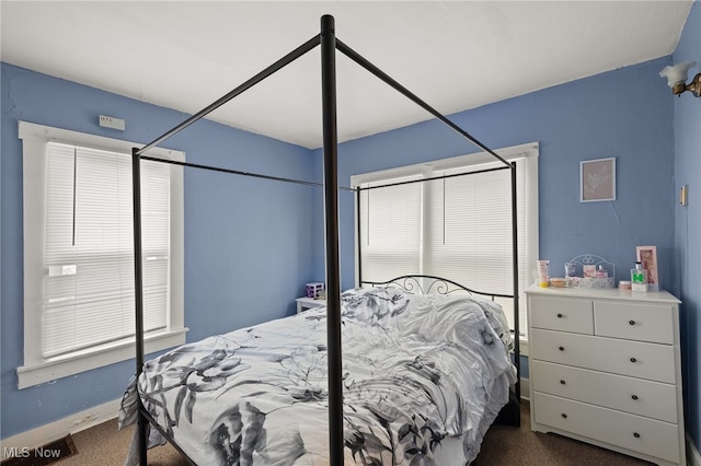 bedroom featuring dark carpet