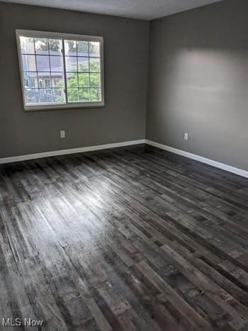 spare room featuring dark hardwood / wood-style flooring