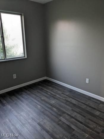 unfurnished room featuring dark hardwood / wood-style floors