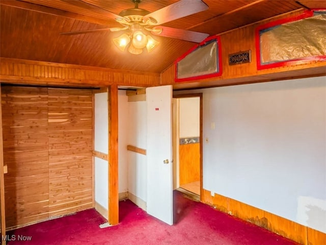 unfurnished bedroom with lofted ceiling, wooden ceiling, and wood walls