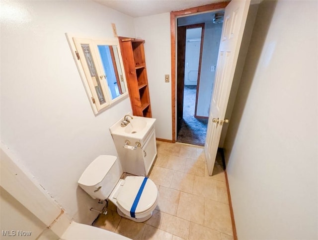 bathroom featuring tile patterned flooring and toilet