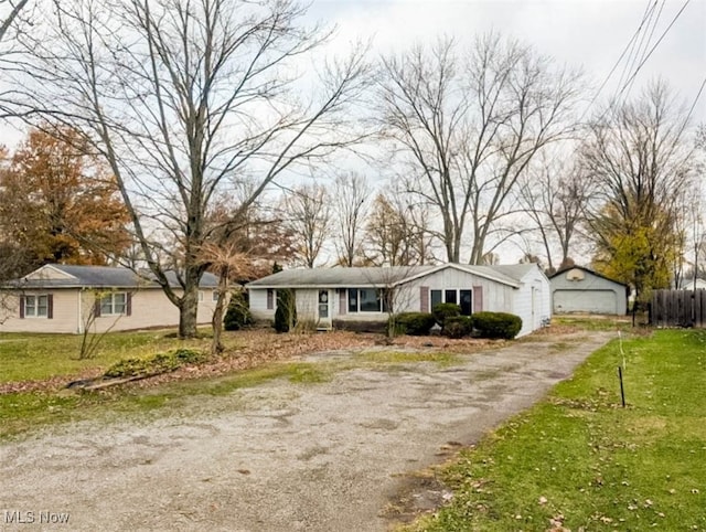 single story home with a garage and a front lawn