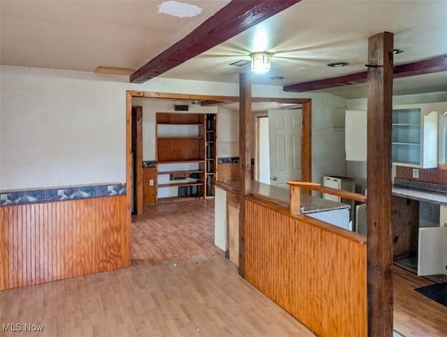 kitchen with beamed ceiling and light wood-type flooring