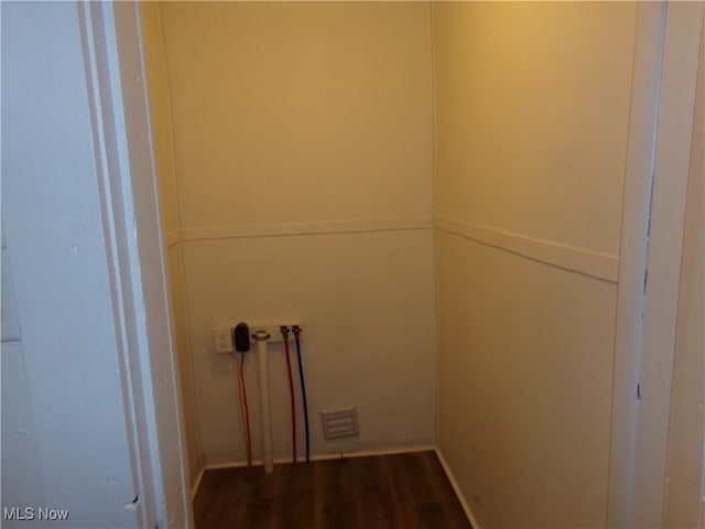 washroom featuring dark wood-type flooring and hookup for a washing machine