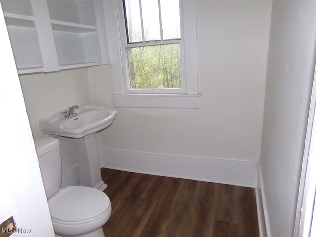 bathroom with hardwood / wood-style floors, toilet, and sink