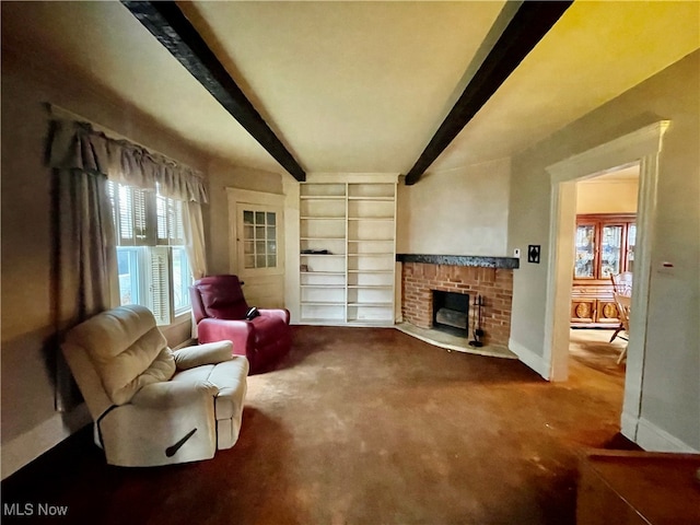 living room with a fireplace, beam ceiling, carpet flooring, and a wealth of natural light