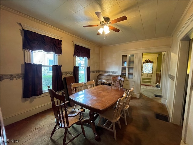 dining space featuring ceiling fan and ornamental molding