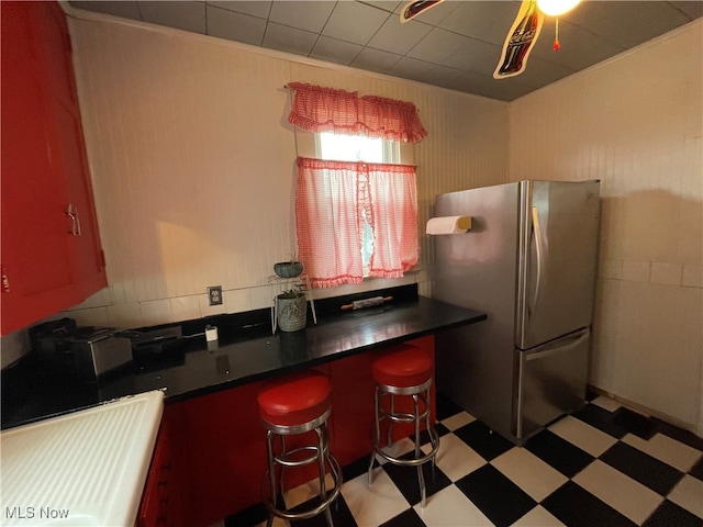 kitchen featuring a breakfast bar and stainless steel fridge