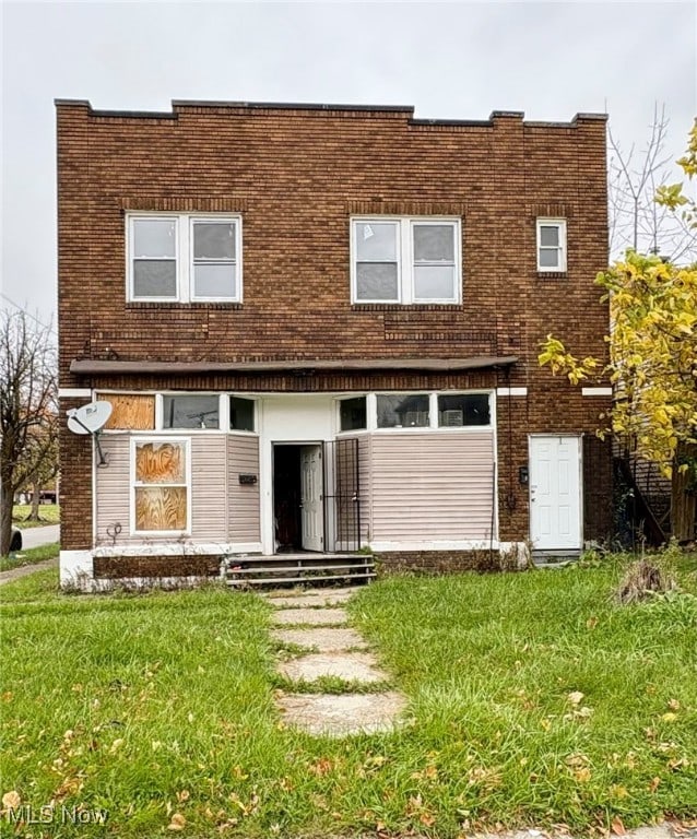 rear view of house featuring a lawn