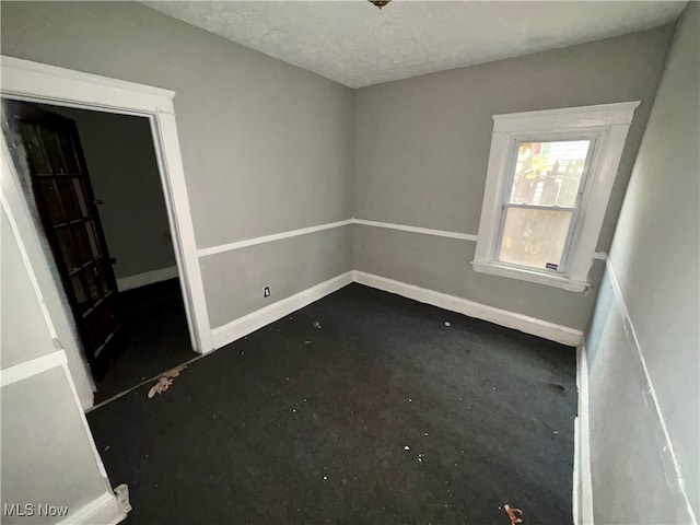 spare room featuring a textured ceiling