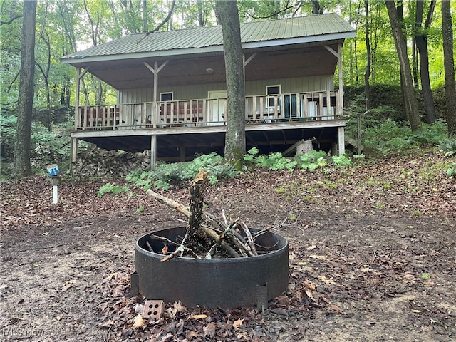 exterior space featuring an outdoor fire pit and a wooden deck