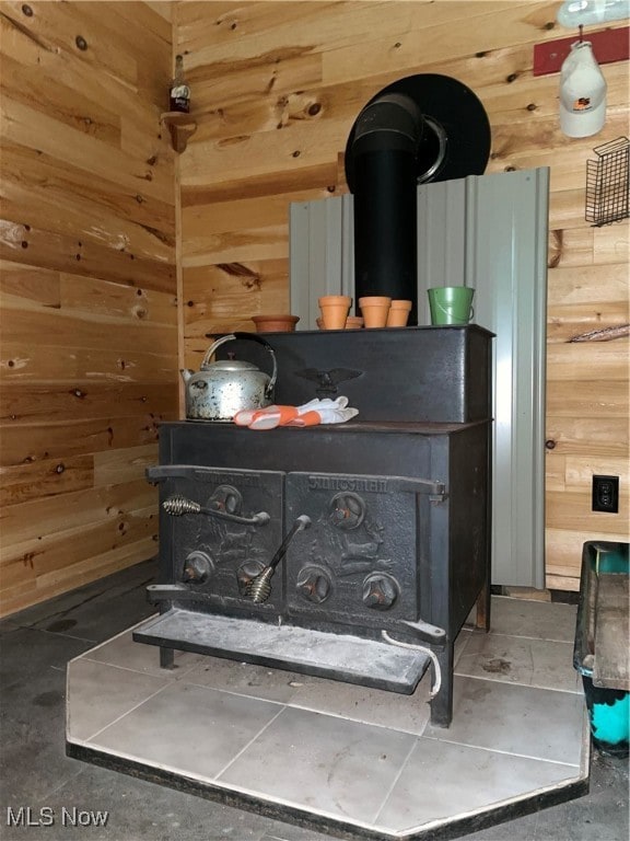 details featuring a wood stove and wooden walls