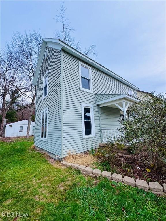 view of side of home featuring a yard