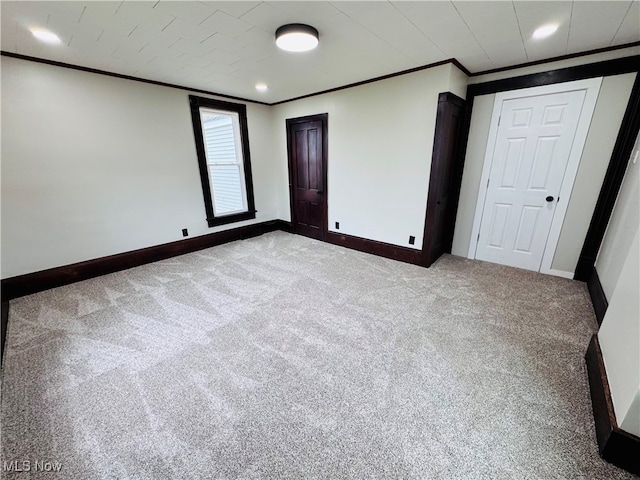 carpeted empty room featuring ornamental molding