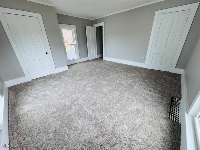 unfurnished bedroom featuring carpet flooring and ornamental molding