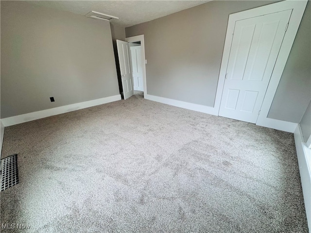 unfurnished bedroom with a closet and carpet floors