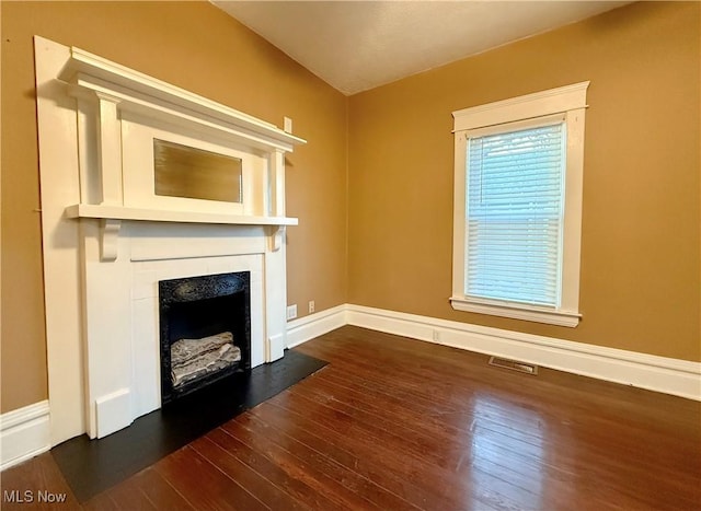 unfurnished living room with dark hardwood / wood-style floors and a fireplace