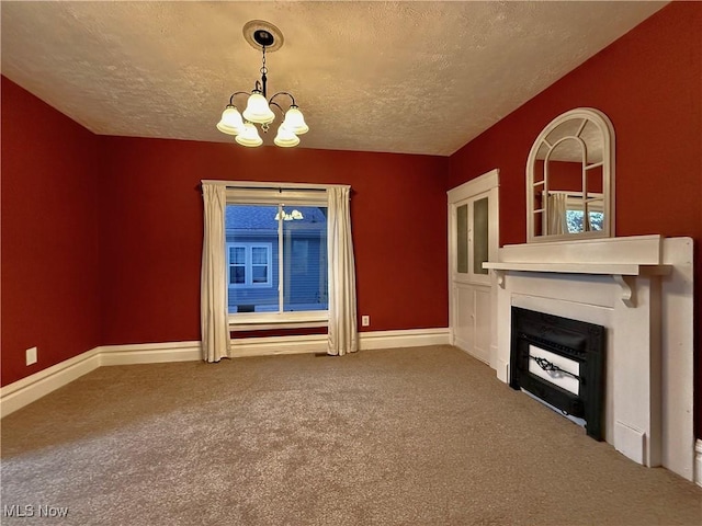 unfurnished living room featuring carpet flooring, a textured ceiling, and a notable chandelier